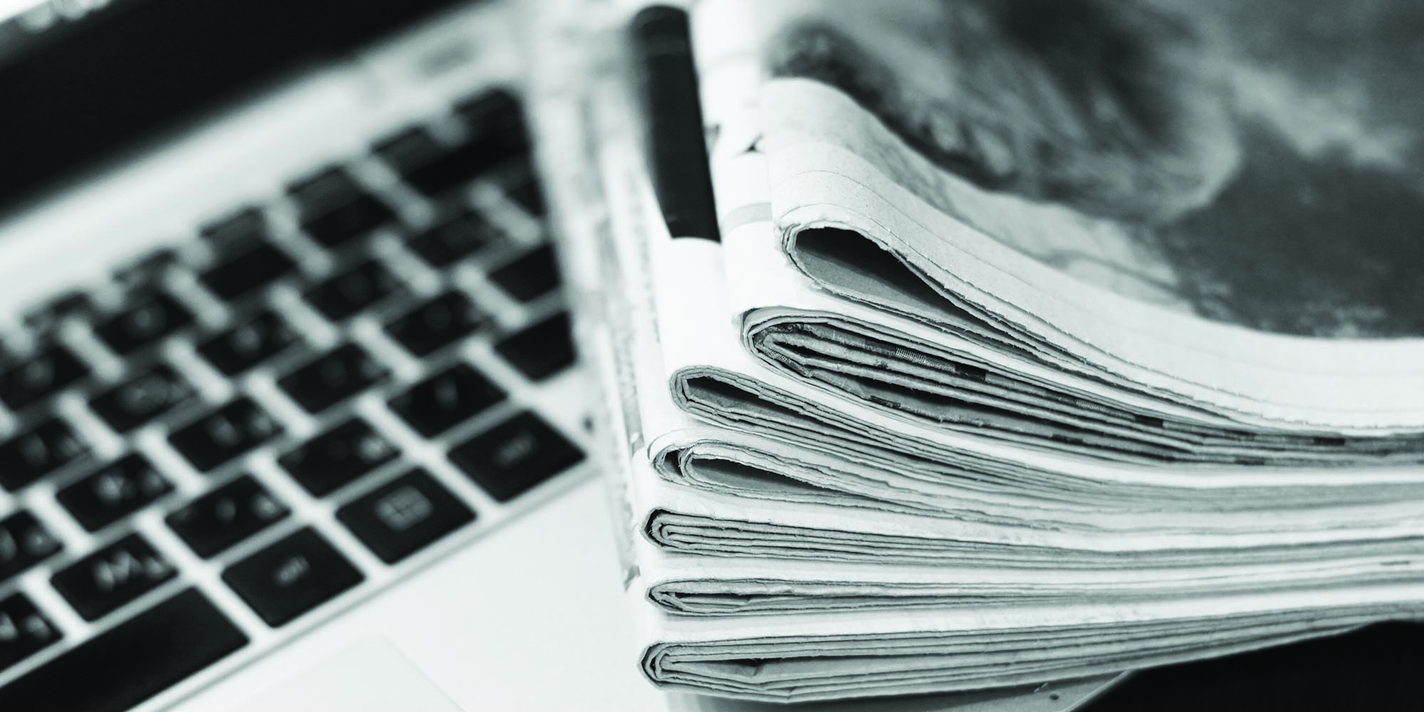 Newspaper and Laptop on a table