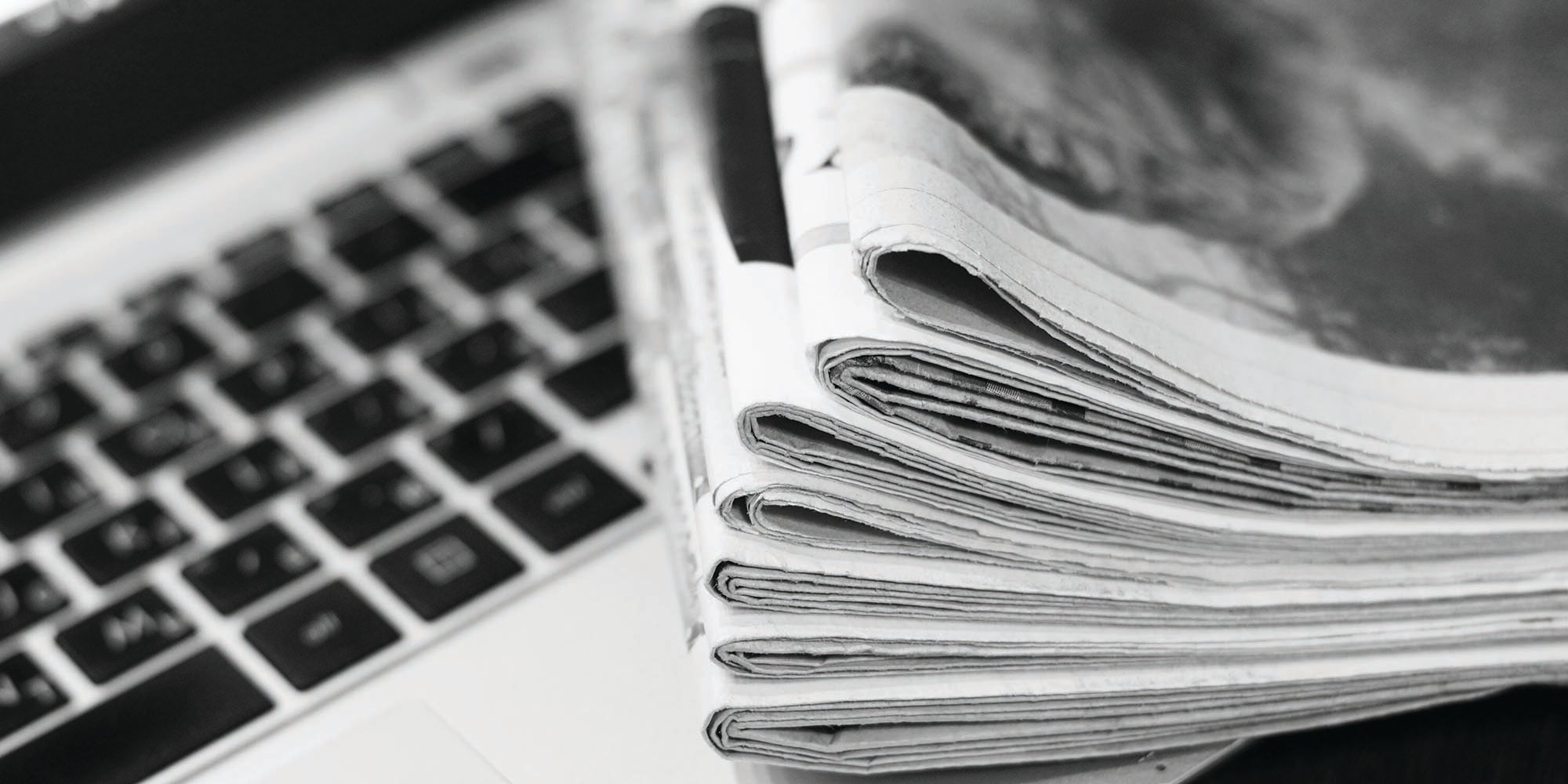 Newspaper and Laptop on a table