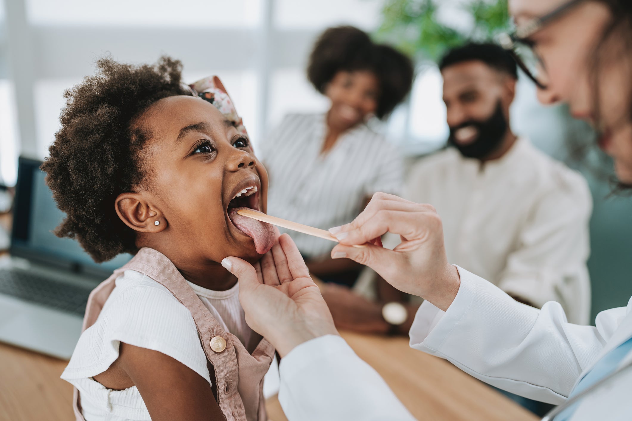 Young girl being examined by doctor
