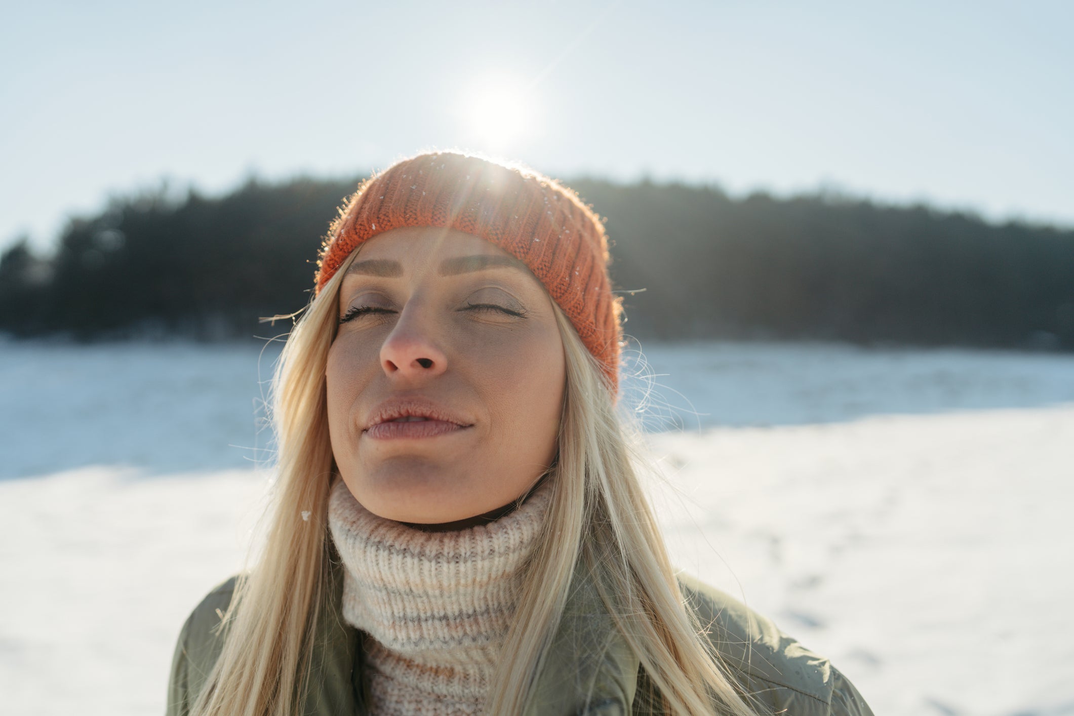 Woman getting vitamin D from the sun while taking a walk outside.