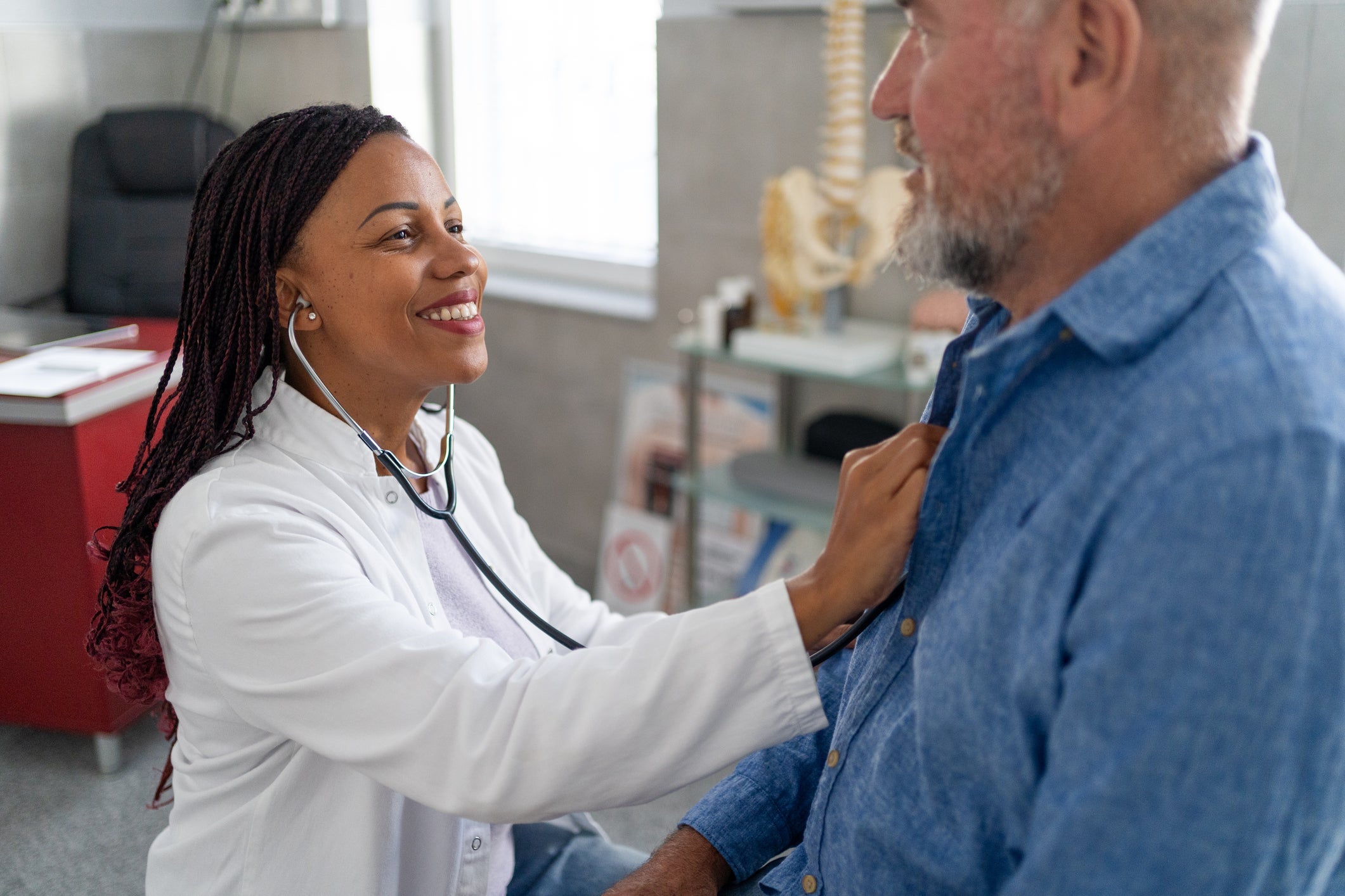 Doctor listening to patient's heartbeat with stethoscope