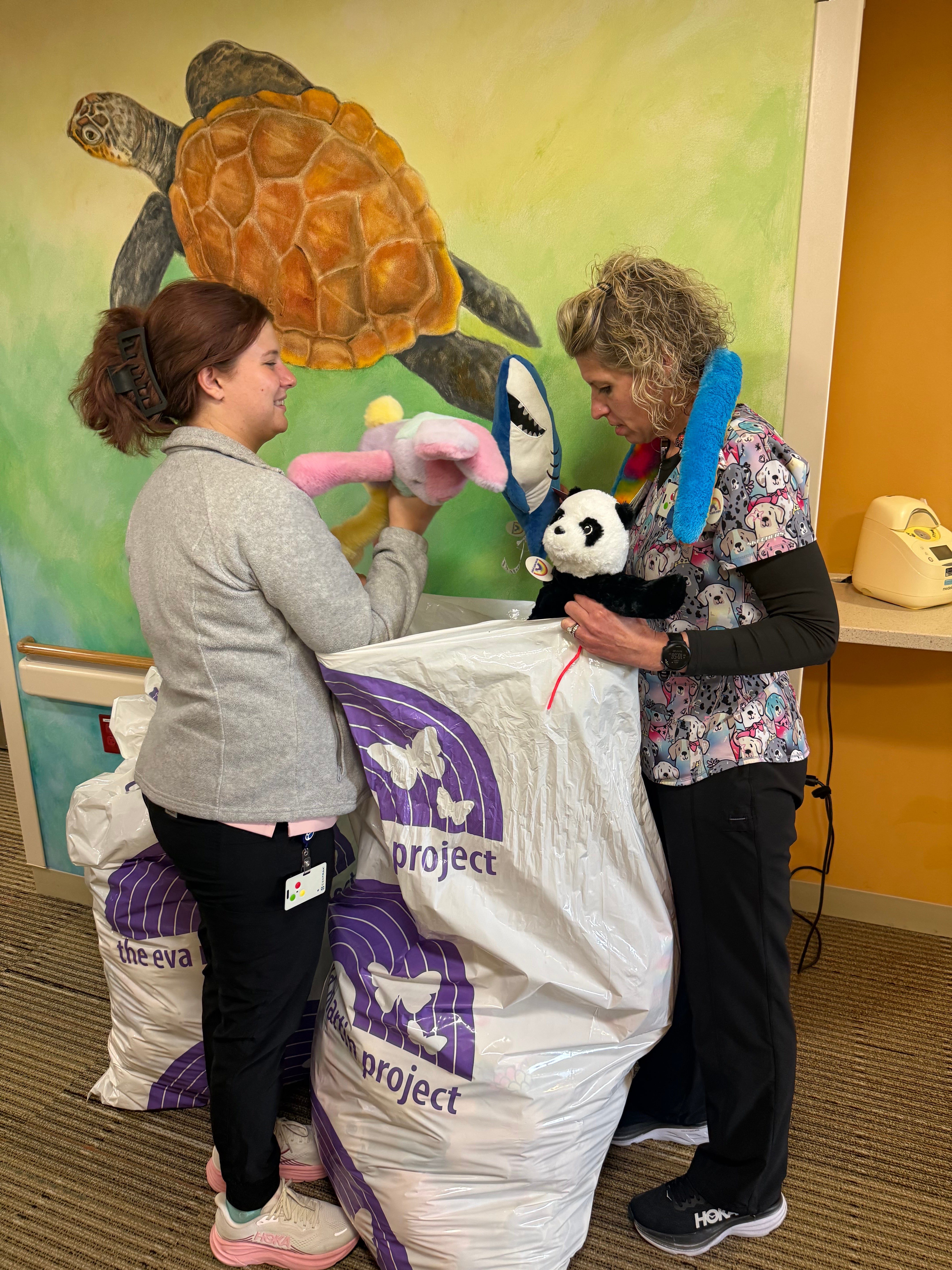 Eva Martin Project volunteers filling donation bags with stuffed animals