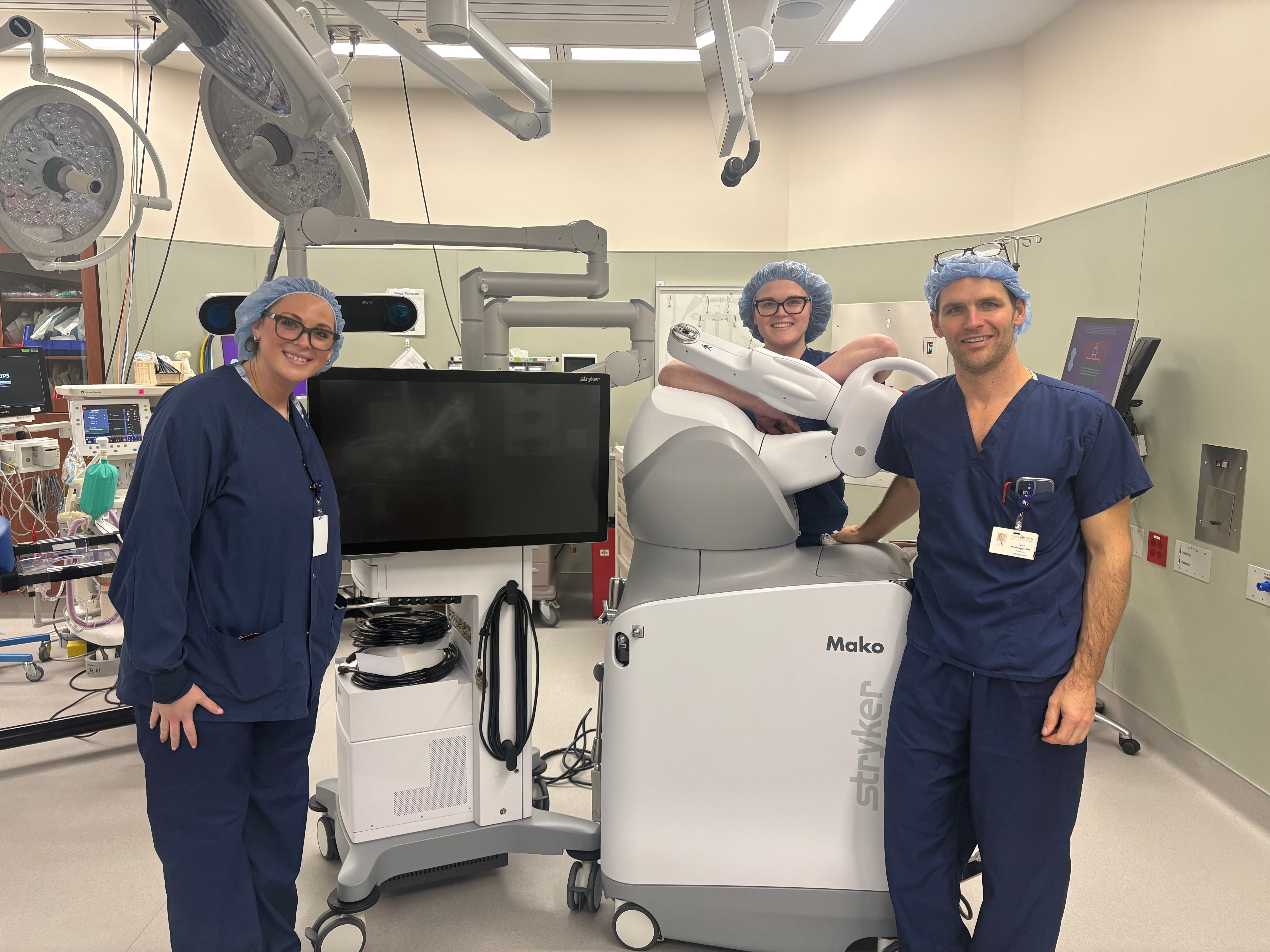 Surgical team displaying new tools acquired via philanthropic efforts