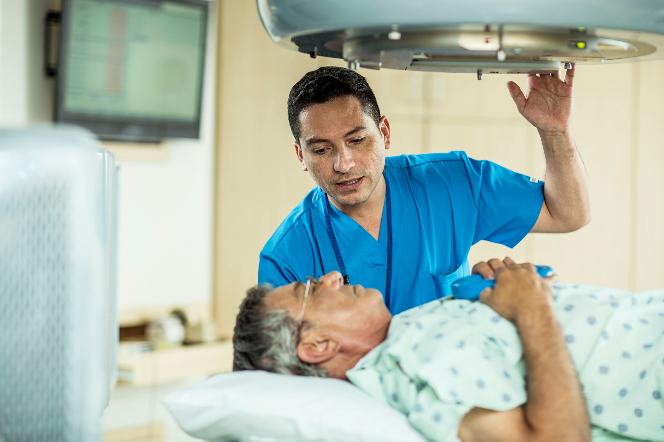 Physician preparing patient for a radiology scan
