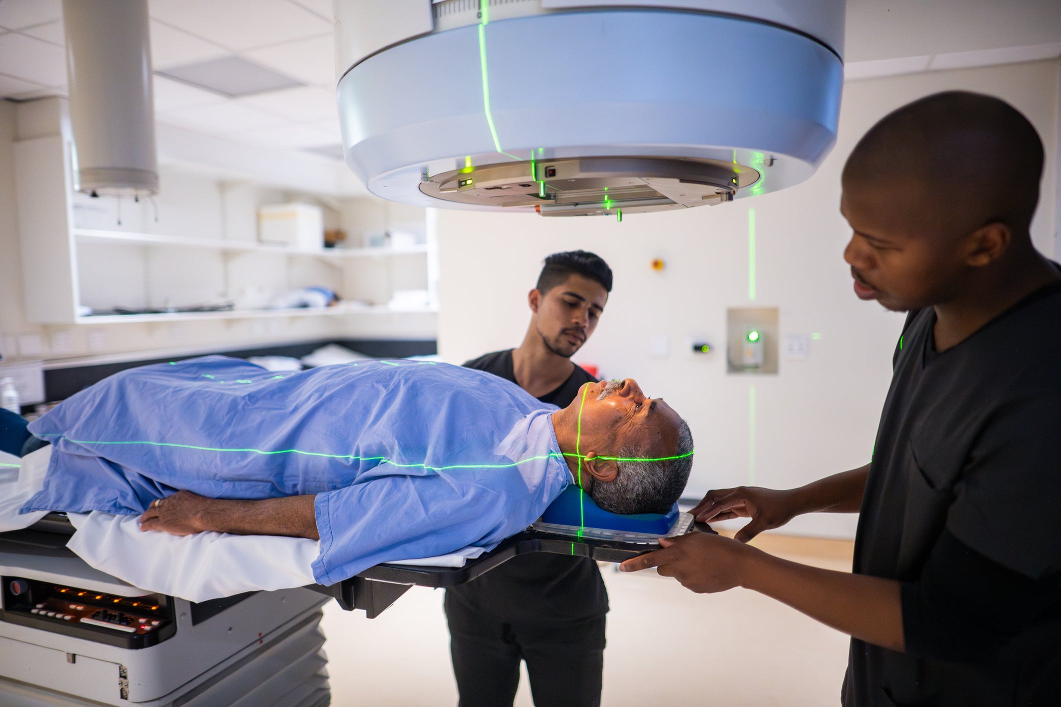 Lab techs working with imaging machine