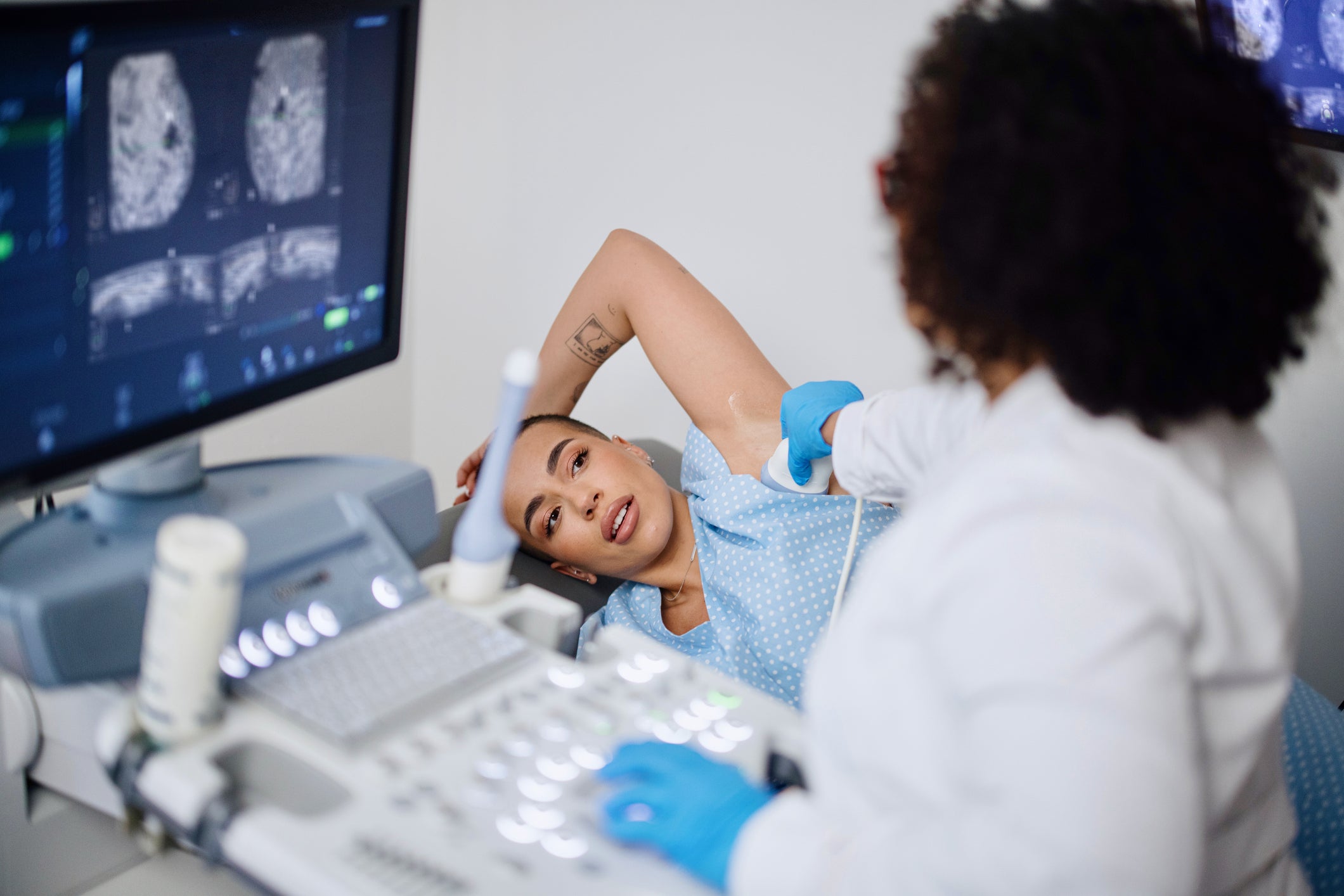 Woman lying on hospital table during a mammogram screening appointment with her physician