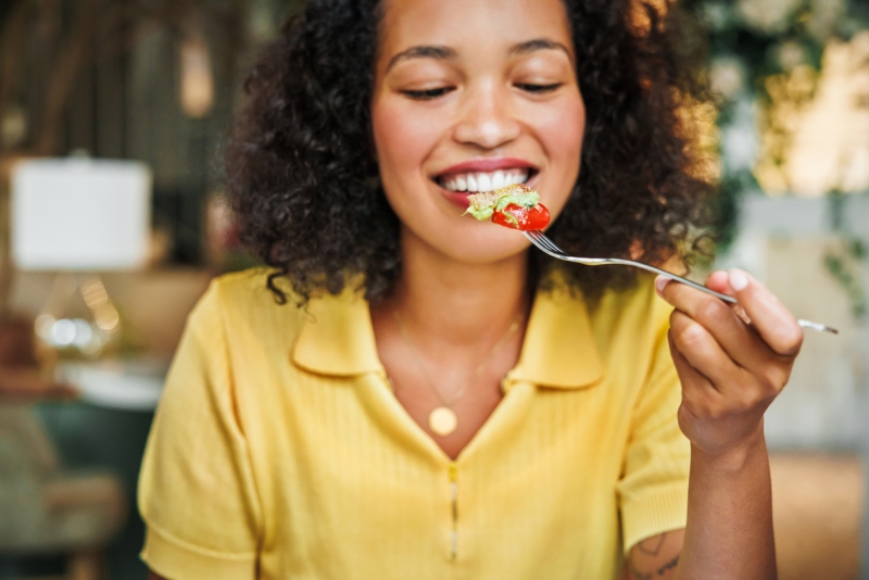 Woman eating a healthy snack consisting of fruit