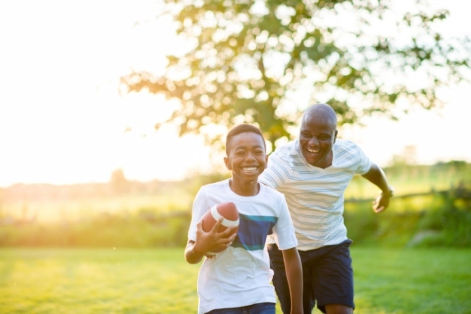 Son and father playing sportsball together