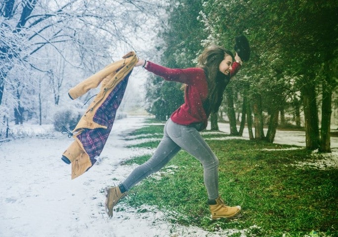 Woman metaphorically transitioning between sessions by stepping out of a snowy scene into a verdant spring scene