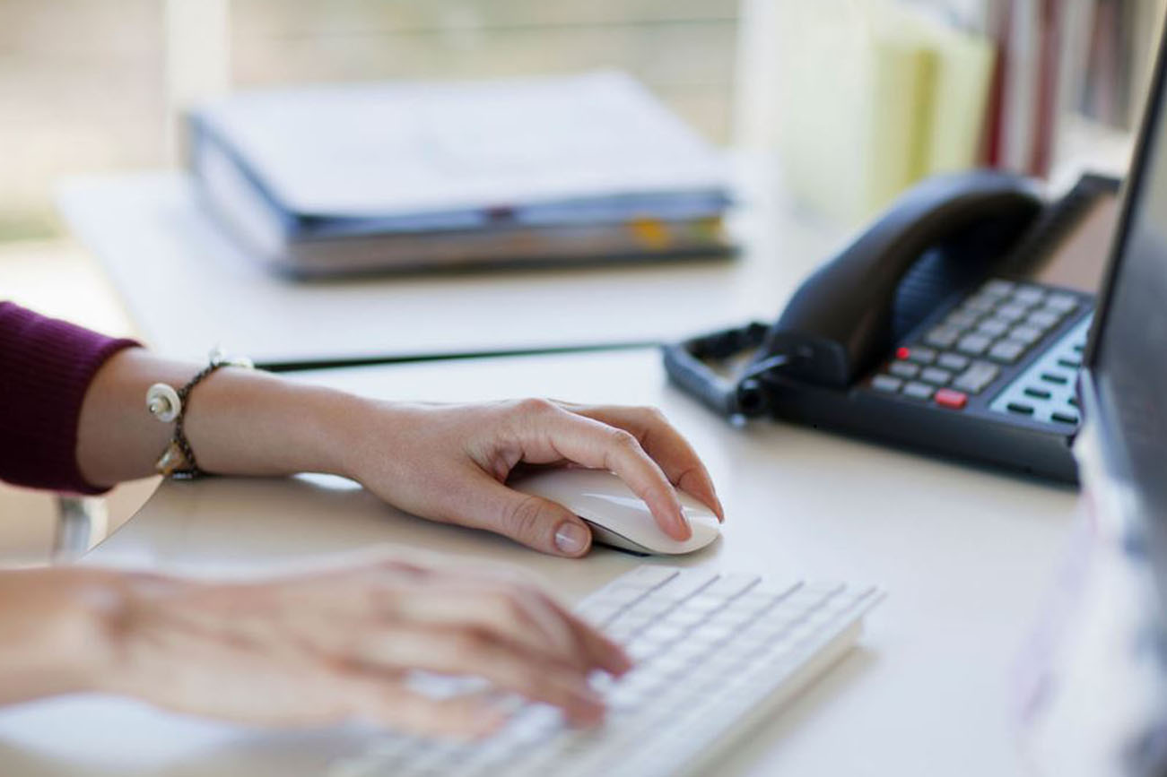 woman starting a new job by completing computer work