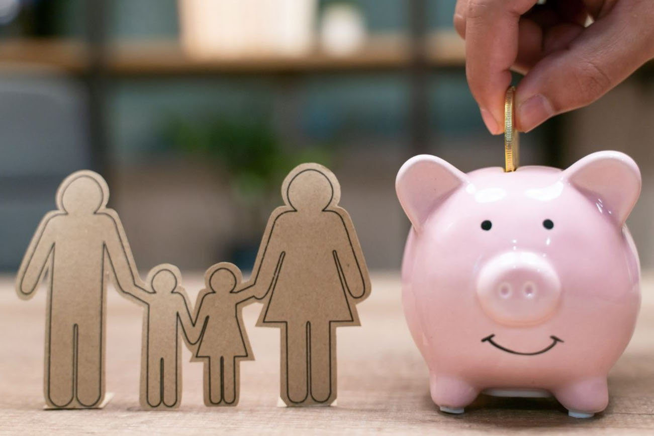 Piggy bank with a cut out of a family