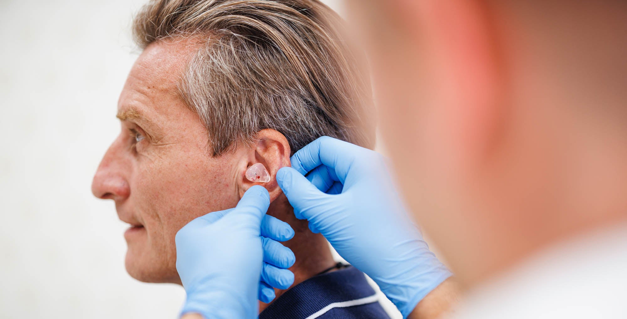 Man exhibiting hearing loss during medical exam