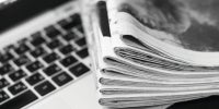 Newspaper and Laptop on a table